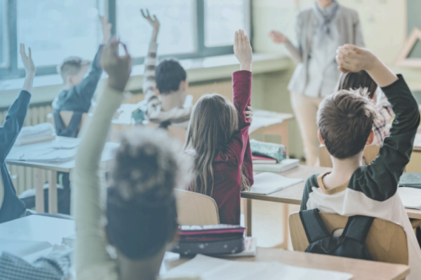 Classroom with children raising hands